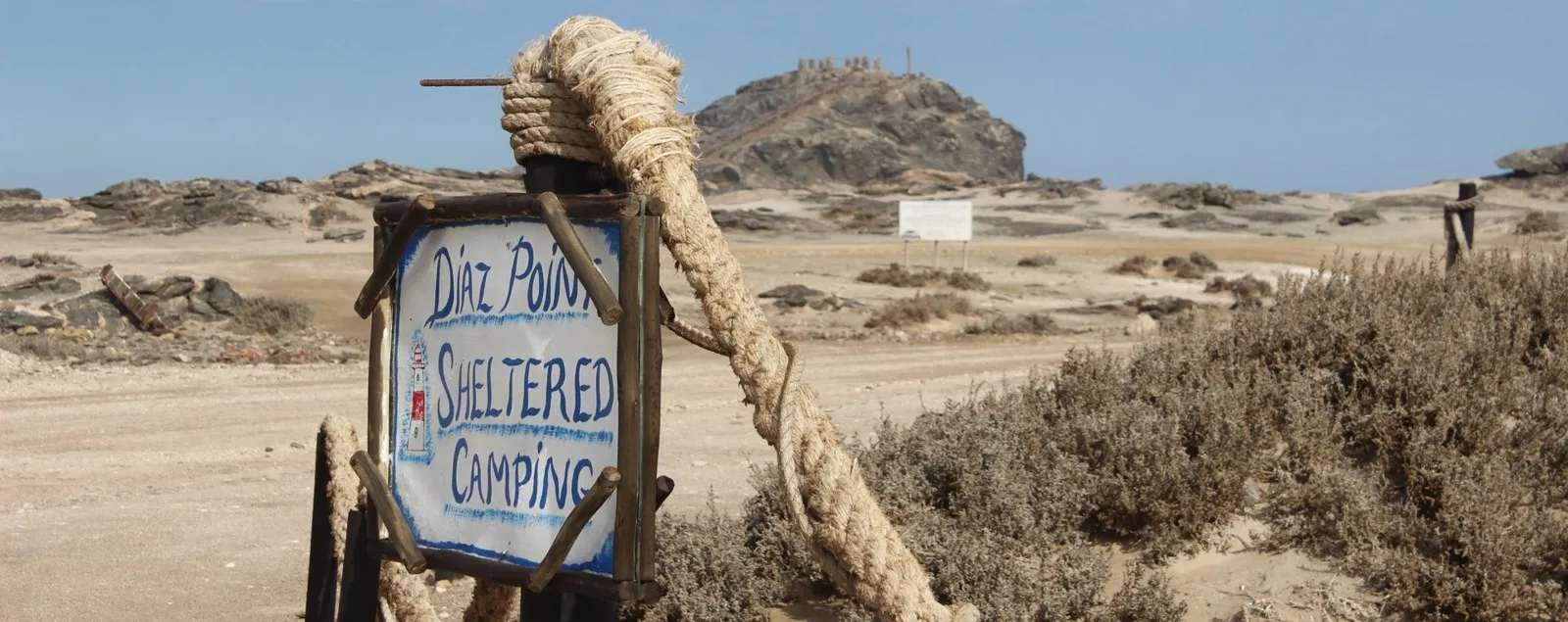 Diaz Point Sheltered Camping sign and desert landscape